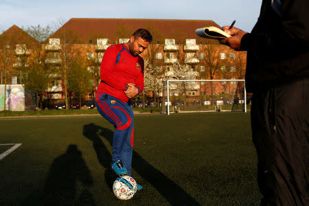 Resident Raouf Al-Hilw, originally from Iraq, practices with his football team F.C. Babylon which is made up of people of Iraqi decent, on a football pitch next to Mjolnerparken, a housing estate that features on the Danish government's "Ghetto List", in Copenhagen, Denmark, May 2, 2018. REUTERS/Andrew Kelly