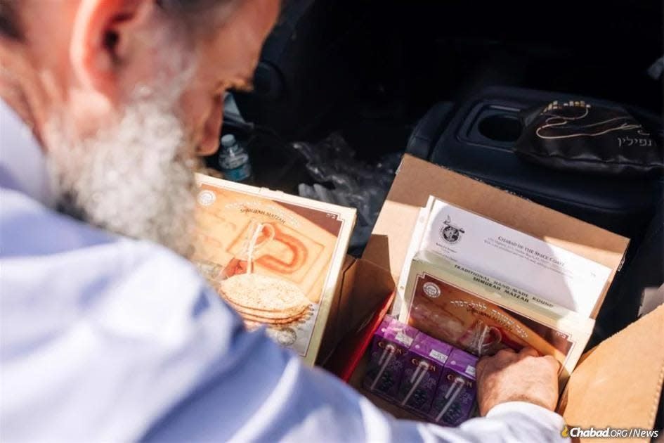 Rabbi Zvi Konikov readies a package of specially-baked matzah and grape juice for Israeli Astronaut Eytan Meir Stibbe, who will be marking Passover aboard the International Space Station