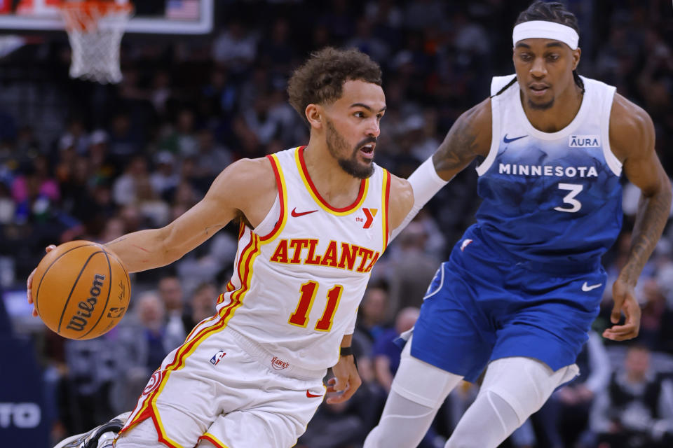 Atlanta Hawks guard Trae Young (11) works around Minnesota Timberwolves forward Jaden McDaniels (3) during the third quarter of an NBA basketball game Friday, April 12, 2024, in Minneapolis. (AP Photo/Bruce Kluckhohn)