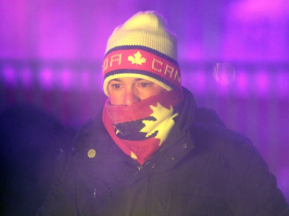 Someone warms up around the Centennial Flame on Parliament Hill in Ottawa in late December 2017. Cover exposed skin and layer up Friday into Saturday, because it's going to be very cold. (Fred Chartrand/The Canadian Press - image credit)