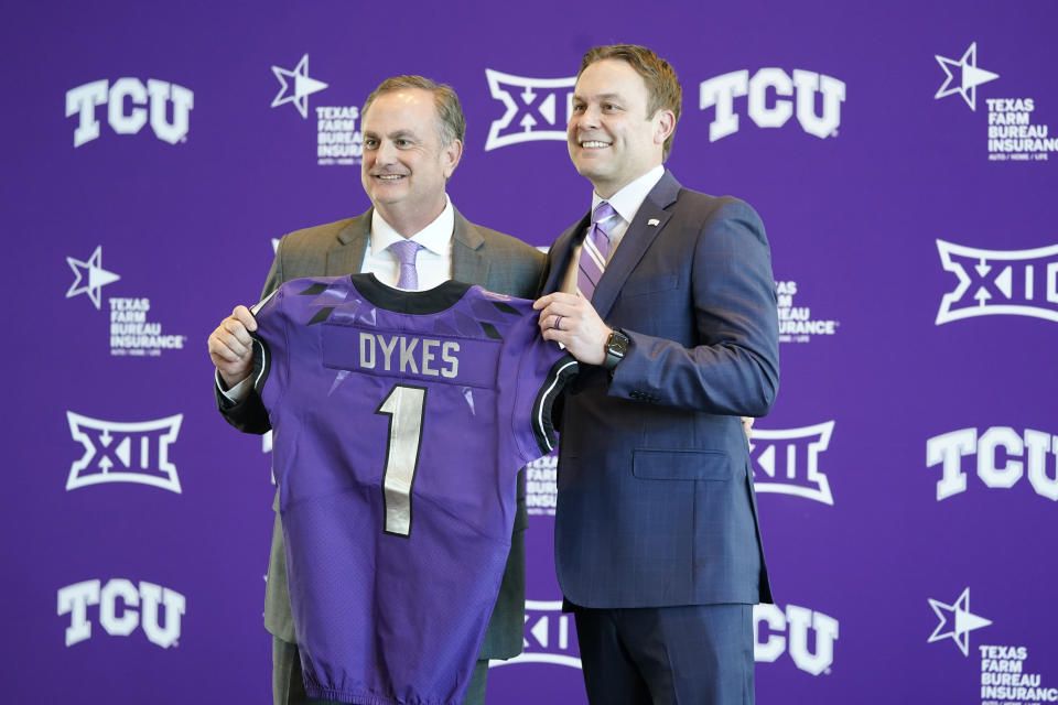 TCU athletic director Jeremiah Donati, right, and new NCAA college football head coach Sonny Dykes pose with a team jersey during an introductory news conference for Dykes in Fort Worth, Texas, Tuesday, Nov. 30, 2021. (AP Photo/LM Otero)