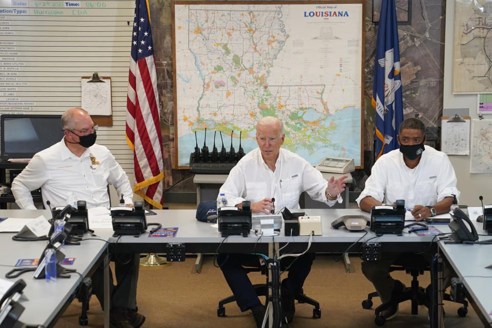 President Joe Biden participates in a briefing about the response to damage caused by Hurricane Ida, at the St. John Parish Emergency Operations Center, Friday, Sept. 3, 2021, in LaPlace, La., as Louisiana Gov. John Bel Edwards, left, and White House senior adviser Cedric Richmond listen. (AP Photo/Evan Vucci)