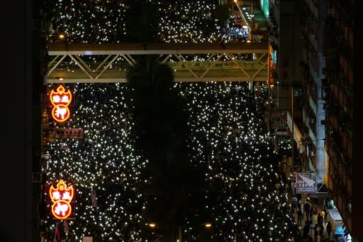 As night fell the crowds switched on their mobile phone torches, creating a glittering carpet of lights that stretched far into the distance, their chants bouncing off the towering skyscrapers above