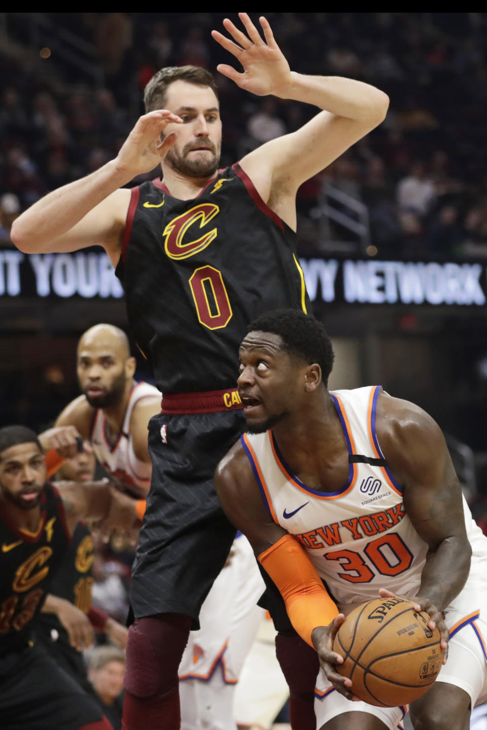 New York Knicks' Julius Randle (30) tries to get past Cleveland Cavaliers' Kevin Love (0) in the second half of an NBA basketball game, Monday, Jan. 20, 2020, in Cleveland. New York won 106-86. (AP Photo/Tony Dejak)