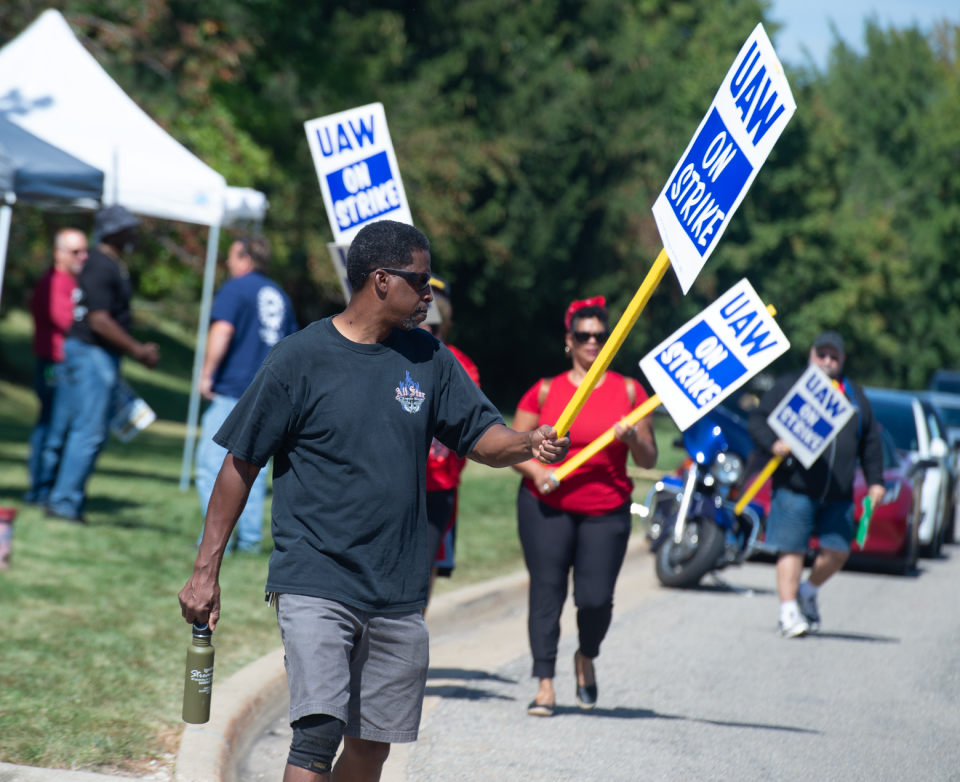 United Auto Workers union member Kip Powell walks with a picket sign Friday at Stellantis parts distribution center in Streetsboro.