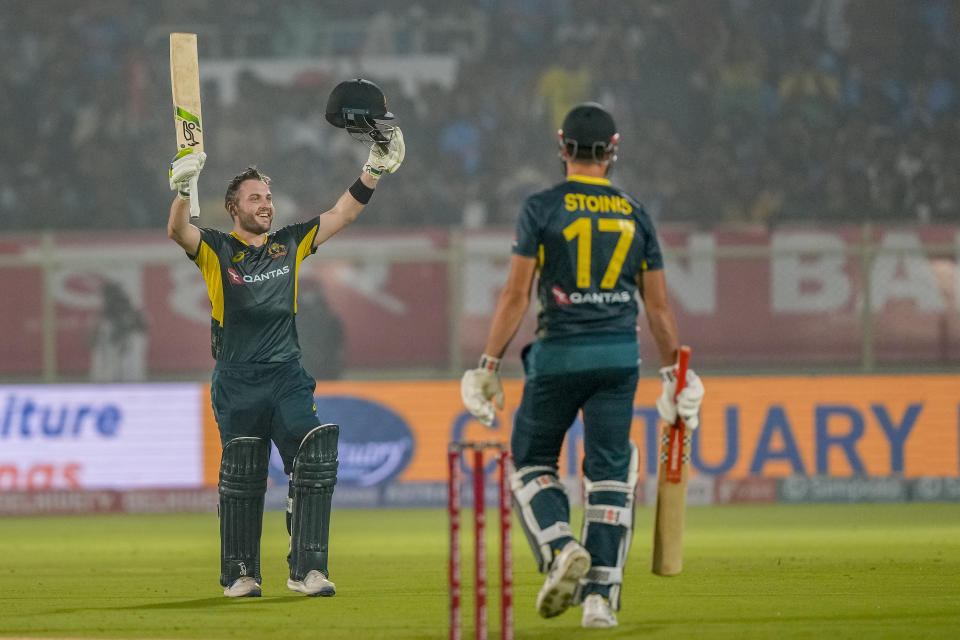 Australia's Josh Inglis, left, celebrates after scoring a century during the first T20 cricket match between India and Australia in Visakhapatnam, India, Thursday, Nov. 23, 2023. (AP Photo/Mahesh Kumar A.)