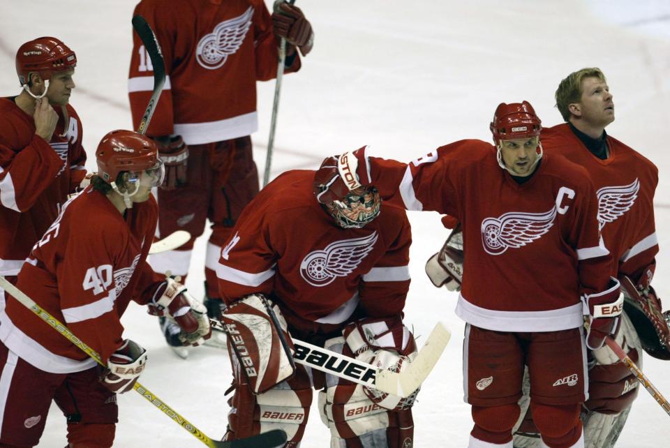 2002-03: The Red Wings finished 48-20-10-4, winning the Central Division. But they lost in a sweep to the Mighty Ducks of Anaheim in the first round. Pictured is goalie Curtis Joseph with the team.