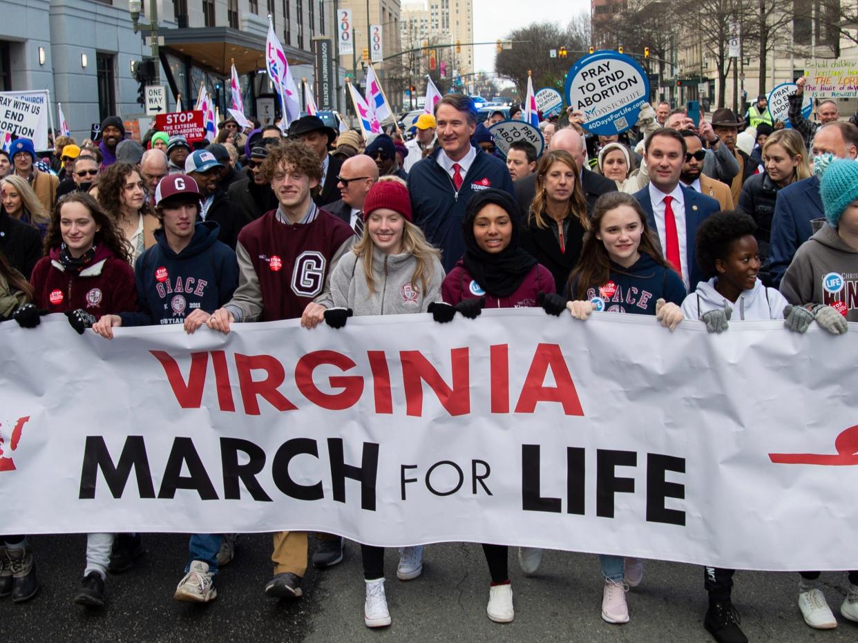 Virginia Gov. Glenn Youngkin marches with attendees at a "March for Life" event on Wednesday, Feb. 1, 2023, in Richmond, Va. (AP Photo/Mike Caudill)