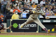 San Diego Padres designated hitter Fernando Tatis Jr., right, jumps out of the way of a pitch in front of Houston Astros catcher Garrett Stubbs, left, during the eighth inning of a baseball game Saturday, May 29, 2021, in Houston. (AP Photo/Michael Wyke)