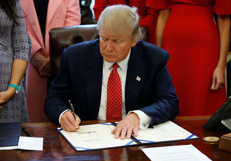 U.S. President Donald Trump signs H.R. 225 in the Oval Office of the White House, in Washington, DC, U.S. February 28, 2017. REUTERS/Joshua Roberts