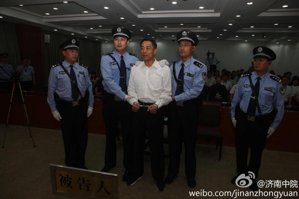 Ousted Chinese politician Bo Xilai (C) is handcuffed after the announcement of his verdict inside the court in Jinan, Shandong province September 22, 2013, in this photo released by Jinan Intermediate People's Court. The court sentenced former Chongqing Municipality Communist Party Secretary Bo to life in prison on Sunday after finding him guilty of all the charges he faced of corruption, taking bribes and abuse of power. REUTERS/Jinan Intermediate People's Court/Handout via Reuters (CHINA - Tags: POLITICS CRIME LAW TPX IMAGES OF THE DAY) ATTENTION EDITORS - THIS IMAGE HAS BEEN SUPPLIED BY A THIRD PARTY. FOR EDITORIAL USE ONLY. NOT FOR SALE FOR MARKETING OR ADVERTISING CAMPAIGNS. THIS PICTURE IS DISTRIBUTED EXACTLY AS RECEIVED BY REUTERS, AS A SERVICE TO CLIENTS. NO SALES. NO ARCHIVES