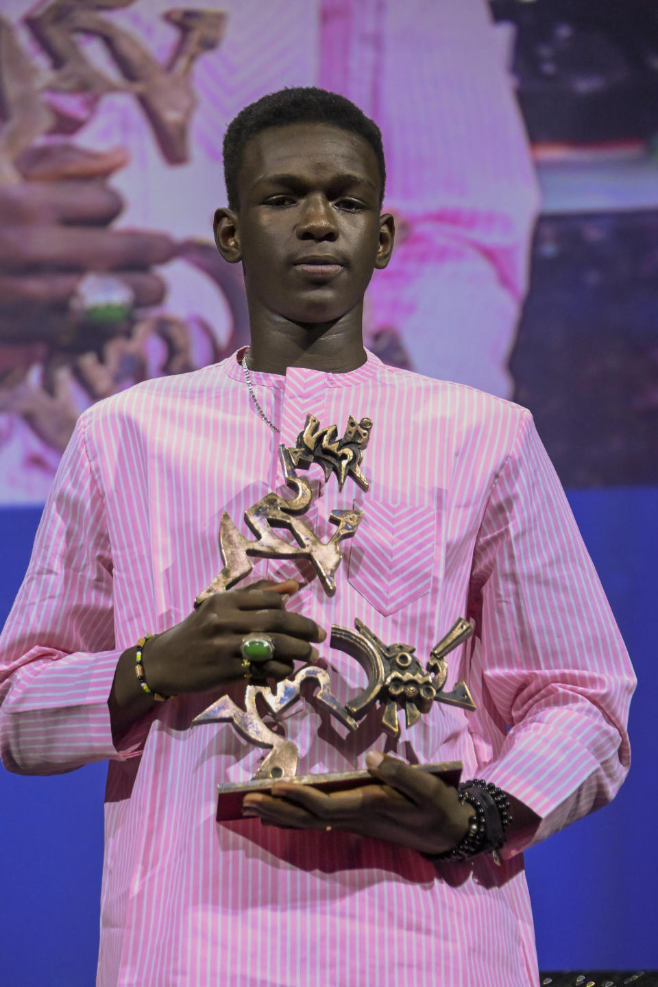 FILE - Actor Seydou Sarr poses with the 'Marcello Mastroianni' award for Best New Young Actor, which he received for his performance in Io Capitano (Me Captain), during the closing ceremony for the 80th edition of the Venice Film Festival in Venice, Italy, Saturday, Sept. 9, 2023. Matteo Garrone's Io Capitano 96th Academy Awards-nominee in the International Feature Film category is inspired by Mamadou Kouassi, a migrant who made the journey from his native Ivory Coast to Italy and now dedicates his life to working with migrants in Castel Volturno, an impoverished city near Naples in southern Italy where thousands of migrants from Africa live. (Gian Mattia D'Alberto/LaPresse via AP)