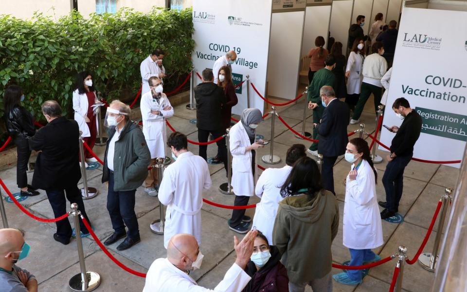 Health workers wait to receive the Pfizer/BioNTech Covid-19 vaccine in Beirut - Reuters