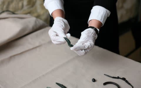 A curator shows off one of the make up objects found at Wroxeter and now thought to be make up applicators - Credit: English Heritage