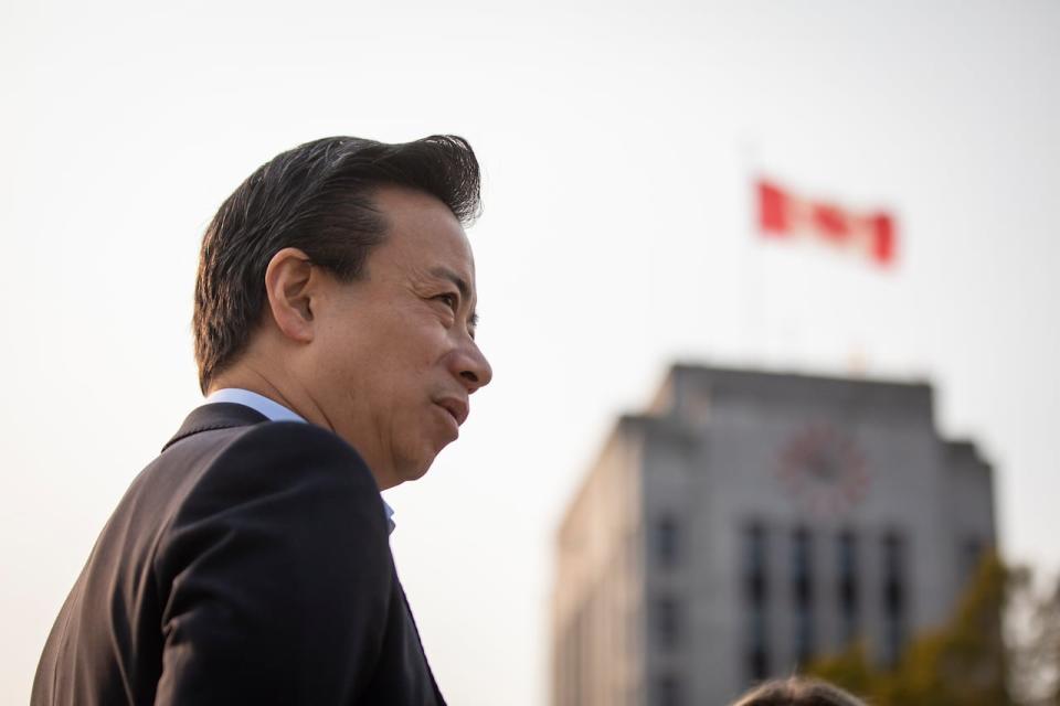 Ken Sim stands near city hall during his first news conference after winning the mayoral election in Vancouver, British Columbia, on Monday, Oct. 17, 2022. 
