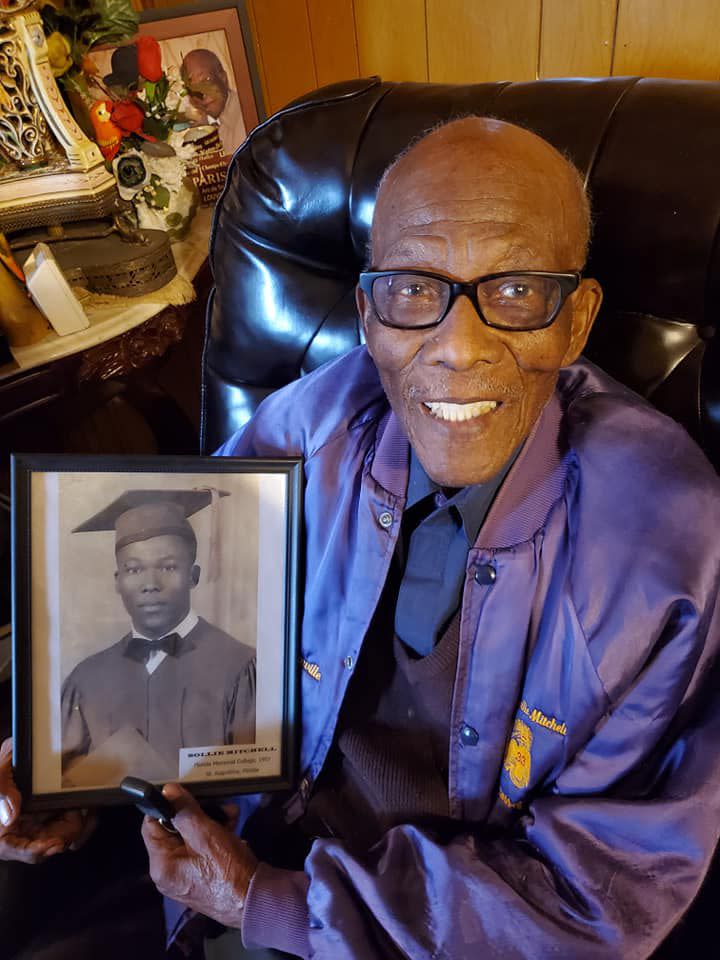 In a 2020 photo, Sollie Mitchell holds his high school graduation photo.