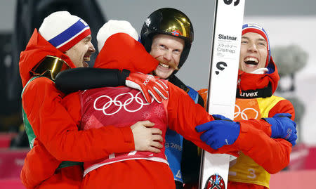 Ski Jumping - Pyeongchang 2018 Winter Olympics - Men's Team Final - Alpensia Ski Jumping Centre - Pyeongchang, South Korea - February 19, 2018 - Robert Johansson of Norway is congratulated by his teammates after his last jump. REUTERS/Dominic Ebenbichler