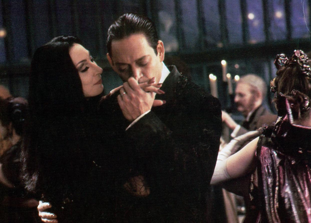 Anjelica Huston is kissed by Raul Julia in a scene from the film 'The Addams Family', 1991.