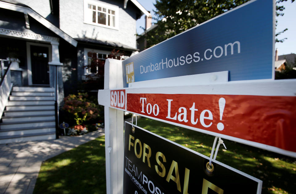 FILE PHOTO: A real estate for sale sign is pictured in front of a home in Vancouver, British Columbia, Canada, September 22, 2016. REUTERS/Ben Nelms/File Photo