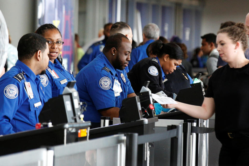 Transportation Security Administration (TSA) agents check-in passengers at JFK airport in the Queens borough of New York City, U.S., May 27, 2016. REUTERS/Brendan McDermid