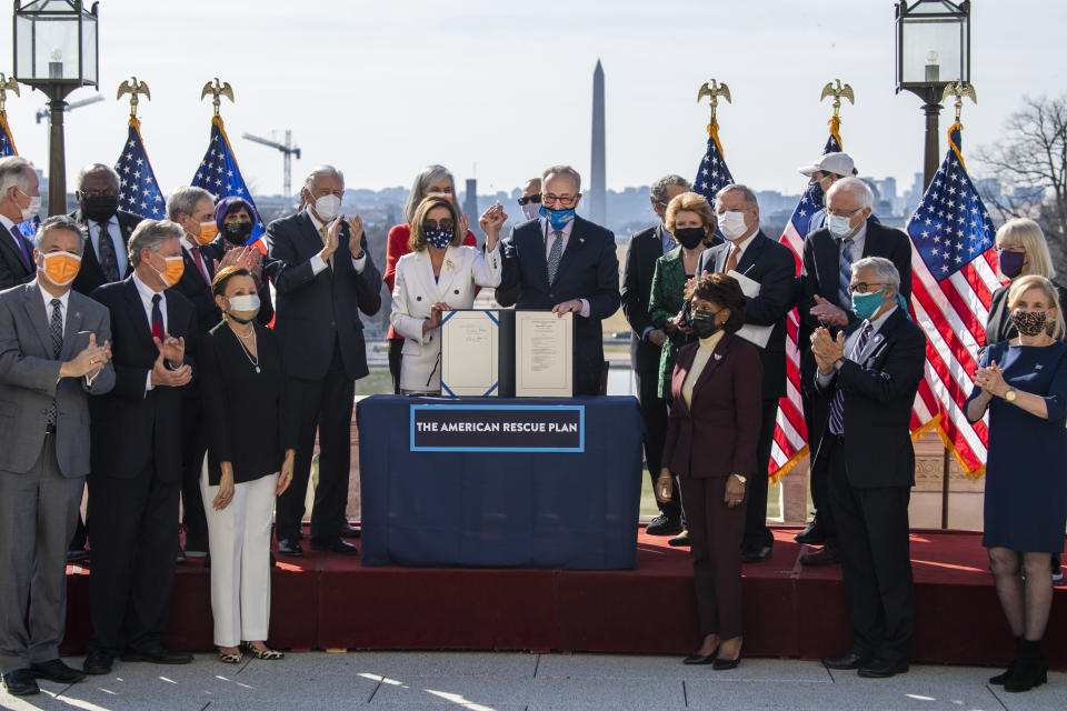 UNITED STATES - MARCH 10: Speaker of the House Nancy Pelosi, D-Calif., and Senate Majority Leader Chuck Schumer, D-N.Y., celebrate signing the American Rescue Plan Act at a bill enrollment ceremony on the West Front of the Capitol after the House passed the $1.9 trillion covid-19 relief package on Wednesday, March 10, 2021. (Photo By Tom Williams/CQ-Roll Call, Inc via Getty Images)