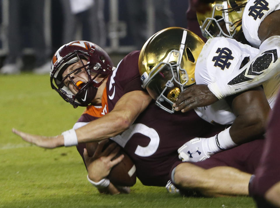 Virginia Tech quarterback Ryan Willis (5) is slammed to the ground on third down near the goal line during the first half of an NCAA college football game in Blacksburg, Va., Saturday, Oct. 6, 2018. (AP Photo/Steve Helber)