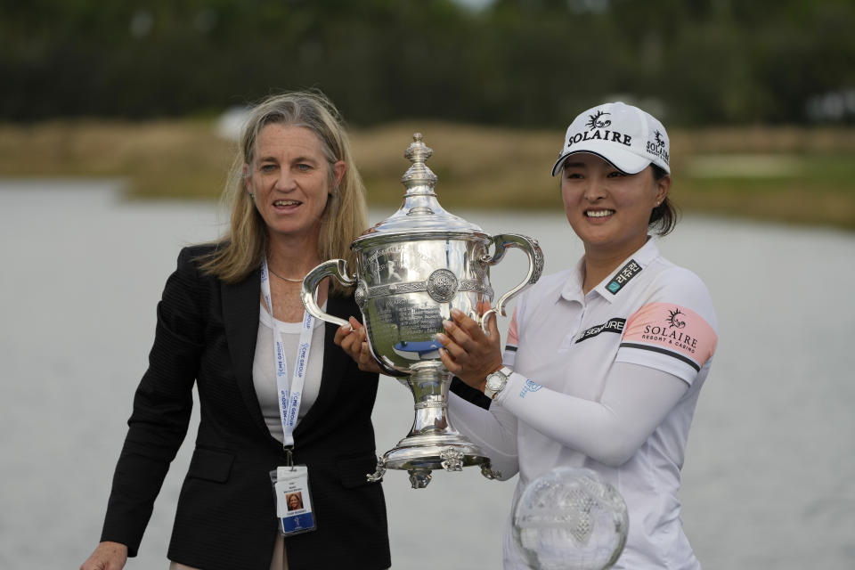 Jin Young Ko, of Korea, right, holds the player of the year trophy along with LPGA Commissioner, Mollie Marcoux, left, after winning the LPGA Tour Championship golf tournament, Sunday, Nov. 21, 2021, in Naples, Fla. (AP Photo/Rebecca Blackwell)