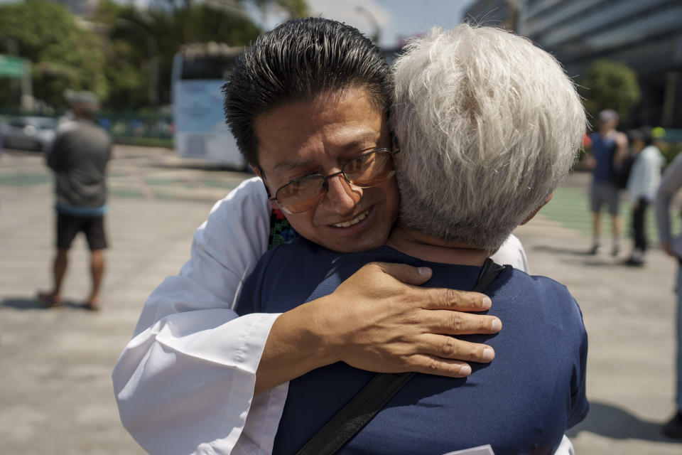 FILE - Jesuit Priest Jorge Atilano Gonzalez Candia embraces a woman after a memorial Mass for all priests and religious men and women who have been murdered in Mexico, in Mexico City, Sunday, July 10, 2022. Gonzalez is an advisor with the Roman Catholic Society of Jesus in Mexico, who was assigned to the case. (AP Photo/Moises Castillo, File)