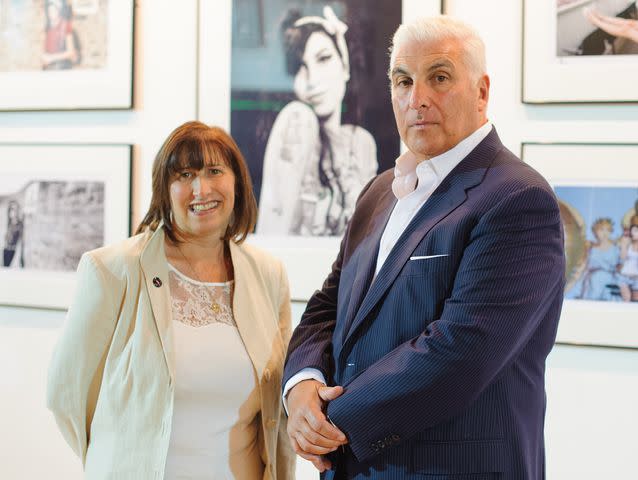 <p>Dominic Lipinski/PA Images/Getty</p> Mitch and Janis Winehouse at the press preview of the 'Amy Winehouse: For You I Was a Flame' exhibition.