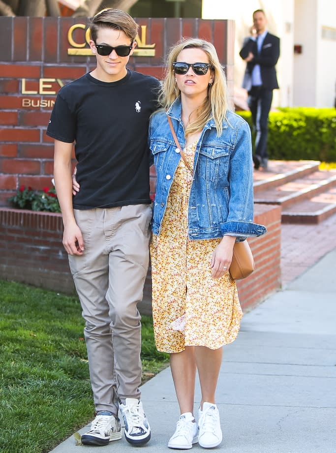 Deacon Phillippe is wearing Converse sneakers on a stroll with mom Reese Witherspoon, who is clad in Adidas Stan Smiths, in 2019. - Credit: Splash