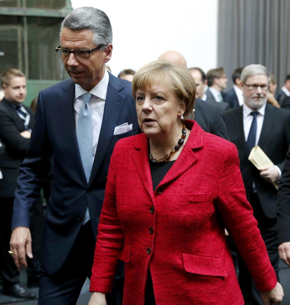 President of the Federation of German Industry (BDI) Ulrich Grillo (L) and German Chancellor Angela Merkel leave the BDI's conference in Berlin, Germany, November 3, 2015. Merkel reiterated on Tuesday that a European-wide approach was needed to tackle the refugee crisis and that a fair distribution of migrants among member states was vital. REUTERS/Fabrizio Bensch