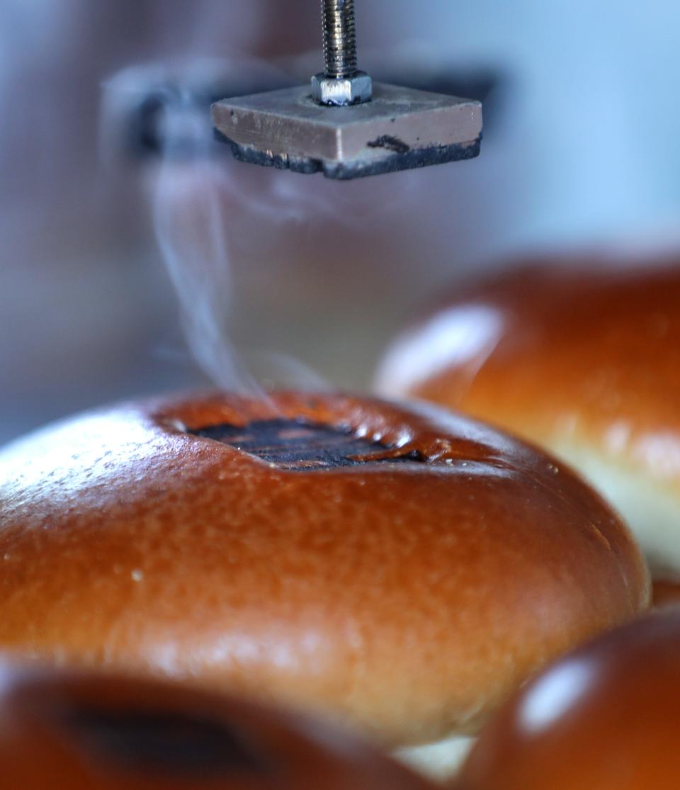 A brioche bun is branded at Hot Biddy’s food truck serving Nashville Style Fried Chicken on Wednesday, April 10, 2024 in Appleton, Wis. 
Wm. Glasheen USA TODAY NETWORK-Wisconsin