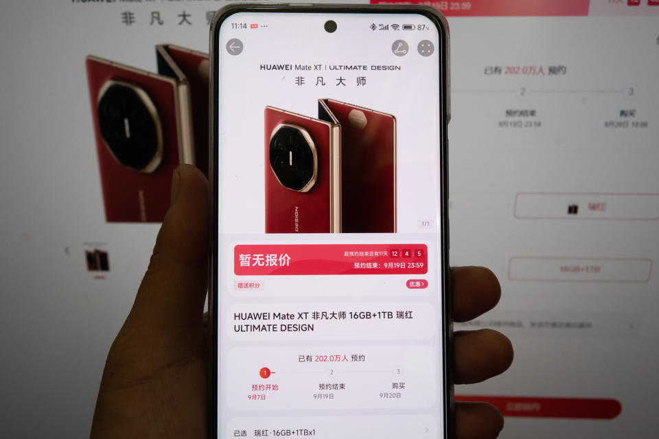 SHANGHAI, CHINA - SEPTEMBER 8, 2024 - A young man checks the booking page of a triple-foldable mobile phone HUAWEI Mate XT ULTIMATE DESIGN at the Huawei Mall in Shanghai, China, Sept 8, 2024. It shows that more than 2 million people have made reservations. (Photo credit should read CFOTO/Future Publishing via Getty Images)