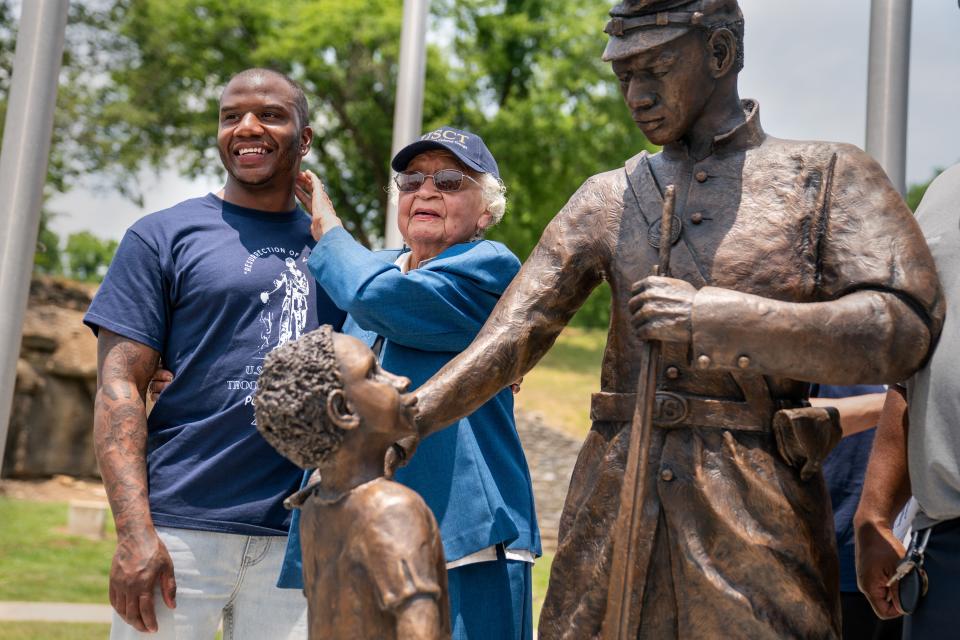 Derrick Coffey, the model for the statue, and Vivian Sims, who helped bring the statue to the park, view the U.S. Colored Troops statue at Cave Springs Park after it was unveiled in Pulaski, Tenn., Saturday, June 17, 2023.