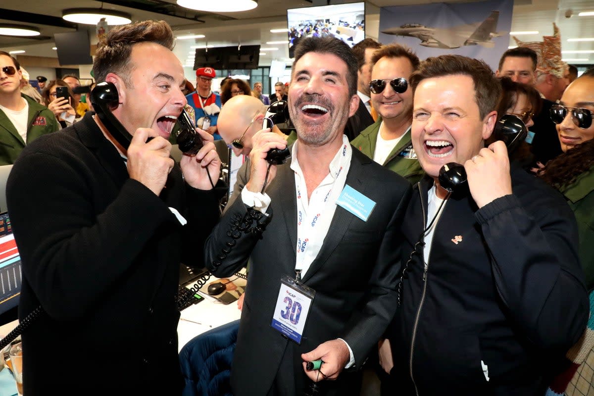 Ant McPartlin and Declan Donnelly with Simon Cowell at ICAP headquarters in London during the broker’s 30th annual charity day, raising money for charities across the globe (Will Wintercross/PA) (PA Media)