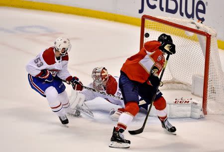 Feb 17, 2019; Sunrise, FL, USA; Florida Panthers center Aleksander Barkov (16) controls the puck past Montreal Canadiens defenseman Victor Mete (left) for a goal against goaltender Antti Niemi (center) during the second period at BB&T Center. Mandatory Credit: Steve Mitchell-USA TODAY Sports