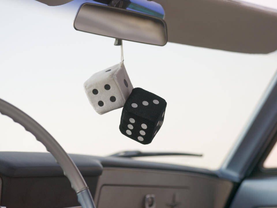 Dice hanging from a rear view car mirror. Source: Getty Images