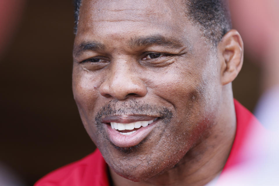 FILE - Herschel Walker, the Republican nominee for the state's U.S. Senate seat, takes questions from the media after a campaign event July 20, 2022, in Athens, Ga. A new report says Georgia Republican Senate nominee Herschel Walker paid for an abortion for his girlfriend in 2009. Walker has vehemently opposed abortion rights and calls the accusation in The Daily Beast a “flat-out lie." The Daily Beast spoke to a woman who said Walker paid for her abortion when they were dating. (Miguel Martinez/Atlanta Journal-Constitution via AP, File)