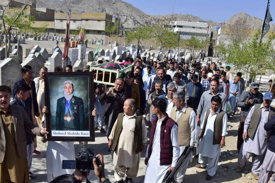 Relatives and mourners carry the coffin of female field hockey player Shahida Raza, who died in the shipwreck tragedy, for her funeral, in Quetta, Pakistan, Friday, March 17, 2023. Raza was among other migrants who died in a shipwreck off Italy's southern coast. The migrants' wooden boat, crammed with passengers who paid smugglers for the voyage from Turkey, broke apart in rough water just off a beach in Calabria. (AP Photo/Arshad Butt)