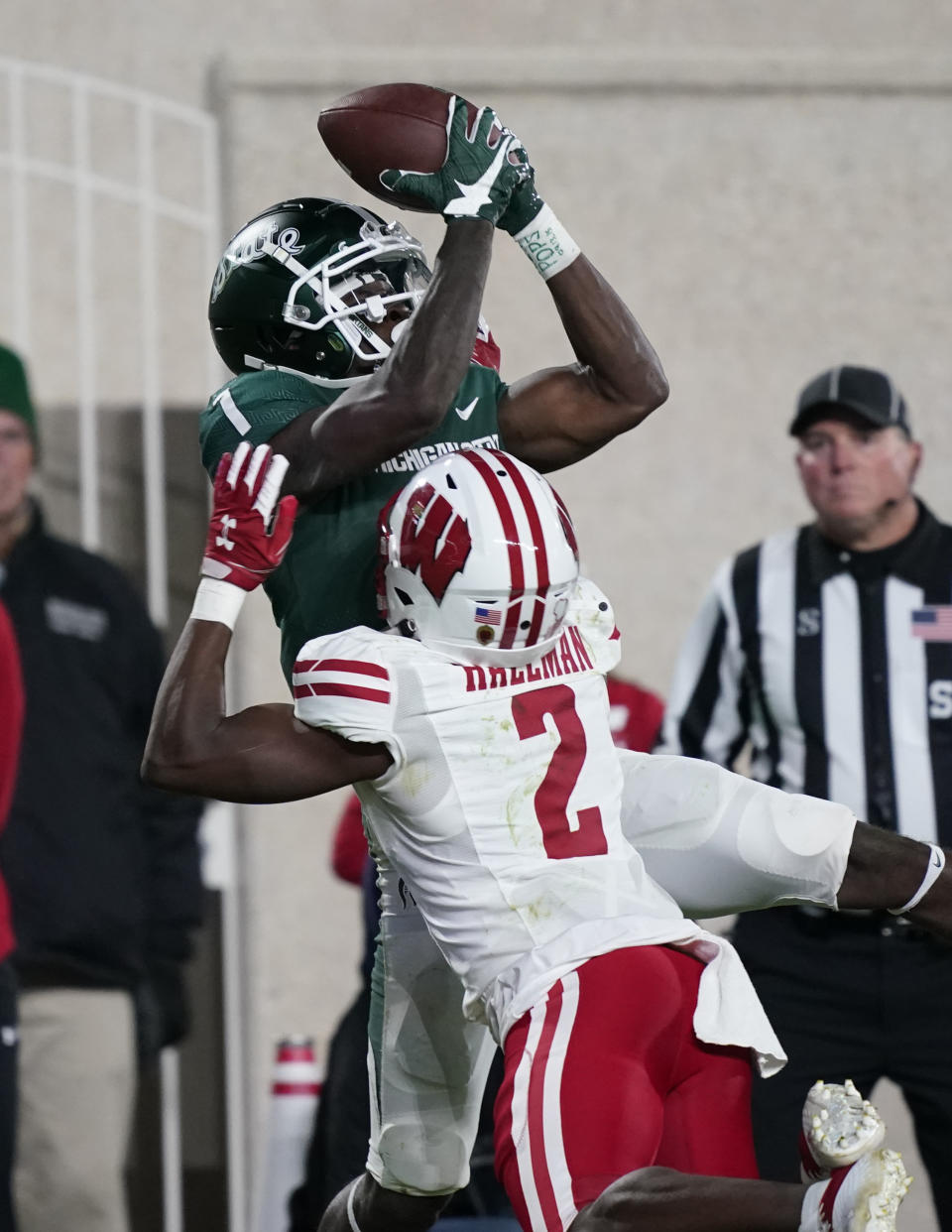 Michigan State wide receiver Jayden Reed (1), defended by Wisconsin cornerback Ricardo Hallman (2), catches the game winning touchdown in overtiime of an NCAA college football game, Saturday, Oct. 15, 2022, in East Lansing, Mich. (AP Photo/Carlos Osorio)