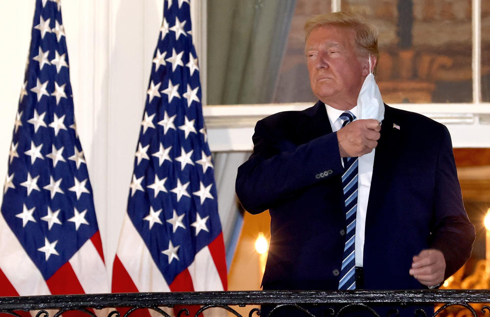 WASHINGTON, DC - OCTOBER 05:  U.S. President Donald Trump removes his mask upon return to the White House from Walter Reed National Military Medical Center on October 05, 2020 in Washington, DC. Trump spent three days hospitalized for coronavirus. (Photo by Win McNamee/Getty Images)