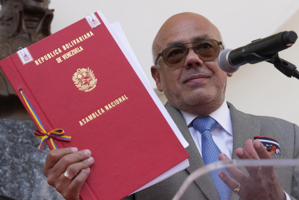 National Assembly President Jorge Rodriguez shows signed documents that agrees on various presidential election dates to propose to the National Elections Council (CNE), at the end of the signing ceremony at the National Assembly, in Caracas, Venezuela, Wednesday, Feb. 28, 2024. (AP Photo/Matias Delacroix)