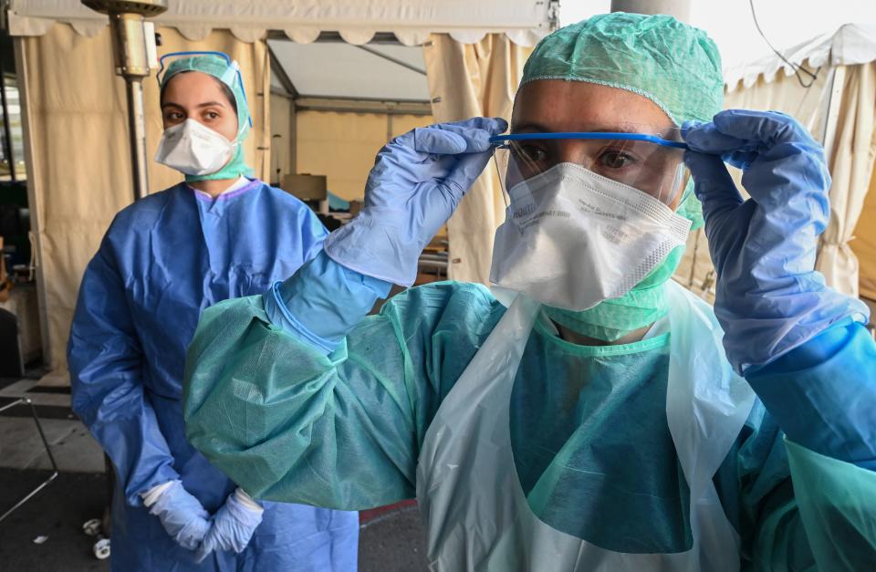 A nurse puts on glasses before examining a patient arriving at an advanced COVID-19 medical station at the Saint Roch hospital, which houses a COVID-19 testing centre, in Montpellier, southern France, on April 8, 2020, on the 23rd day of a lockdown in France aimed at curbing the spread of the COVID-19 pandemic, caused by the novel coronavirus. -  (Photo by Pascal GUYOT / AFP) (Photo by PASCAL GUYOT/AFP via Getty Images)