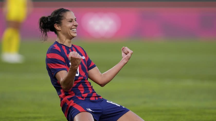 Carli Lloyd celebrates scoring against Australia in the women's bronze medal soccer match