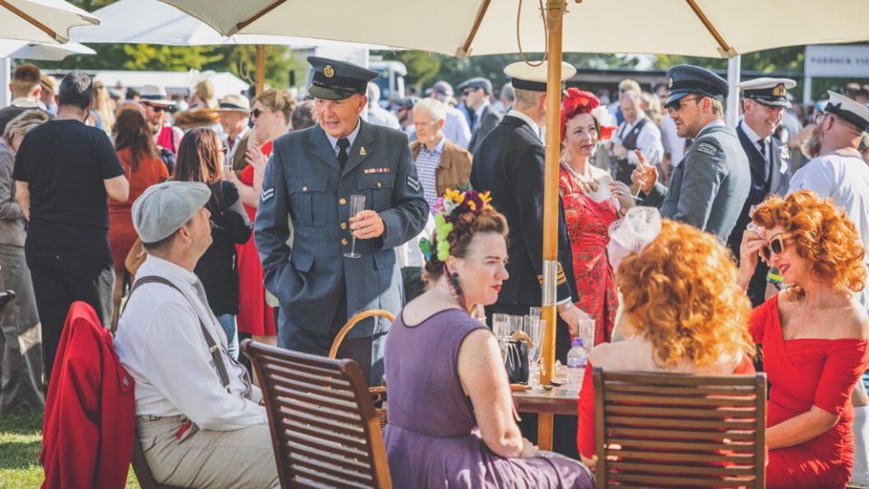 Attendees socialize in period-correct attire. - Credit: Photo: Courtesy of Jaguar Classic.