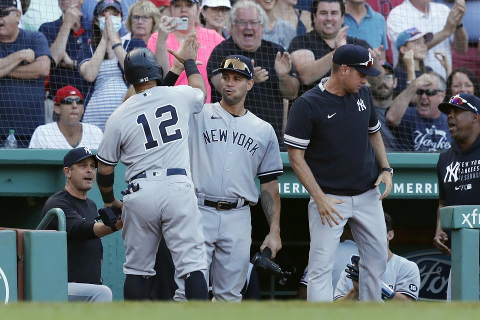 New York Yankees' Rougned Odor (12) celebrates after scoring on an RBI-single by Gleyber Torres during the eighth inning of a baseball game against the Boston Red Sox, Saturday, July 24, 2021, in Boston. (AP Photo/Michael Dwyer)