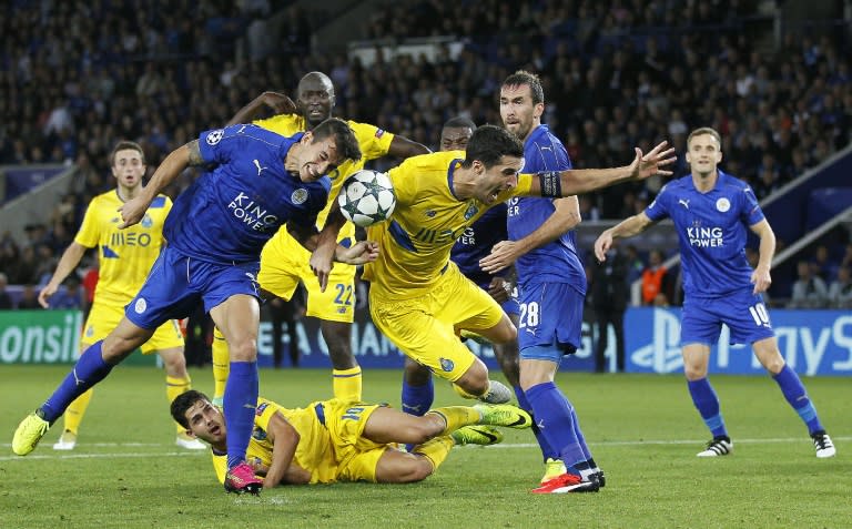 Leicester City's Luis Hernandez (L) fights for the ball with Porto's Ivan Marcano during their UEFA Champions League Group G match, at the King Power Stadium in Leicester, on Septmeber 27, 2016