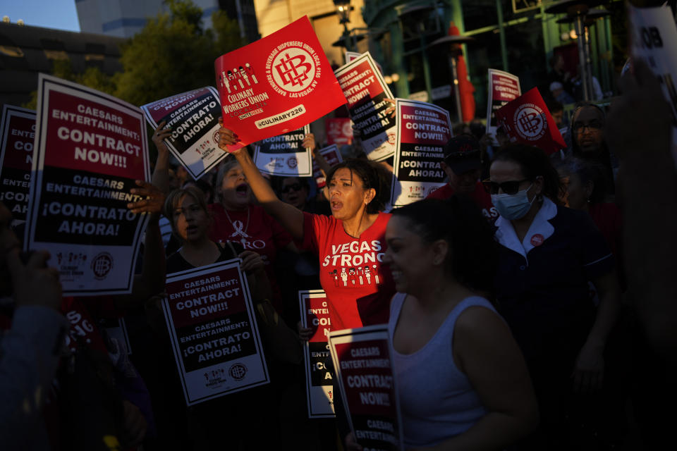 Members of the Culinary Workers Union rally along the Strip, Wednesday, Oct. 25, 2023, in Las Vegas. Thousands of hotel workers fighting for new union contracts rallied Wednesday night on the Las Vegas Strip, where rush-hour traffic was disrupted when some members blocked the road before being detained by police. (AP Photo/John Locher)