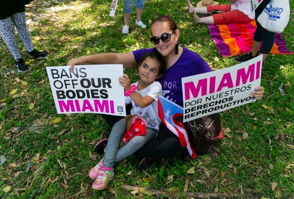 Leslie Rodriguez, and her daughter, Gianna Velez, 5, from North Miami Beach, hold signs while attending the Bans Off Our Bodies rally at Ives Estates Park in Miami, Florida on Saturday, May 14, 2022. The rally was held in opposition of the leaked draft opinion from the U.S. Supreme Court which aims to overturn Roe v. Wade, removing women’s rights to an abortion.