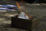 Pro-China supporters burn a picture of U.S. President Donald Trump during a protest against the U.S. sanctions outside the U.S. Consulate in Hong Kong Saturday, Aug. 8, 2020. The U.S. on Friday imposed sanctions on Hong Kong officials, including the pro-China leader of the government, accusing them of cooperating with Beijing's effort to undermine autonomy and crack down on freedom in the former British colony. (AP Photo/Vincent Yu)